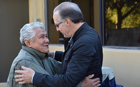 Attorney hugging a man